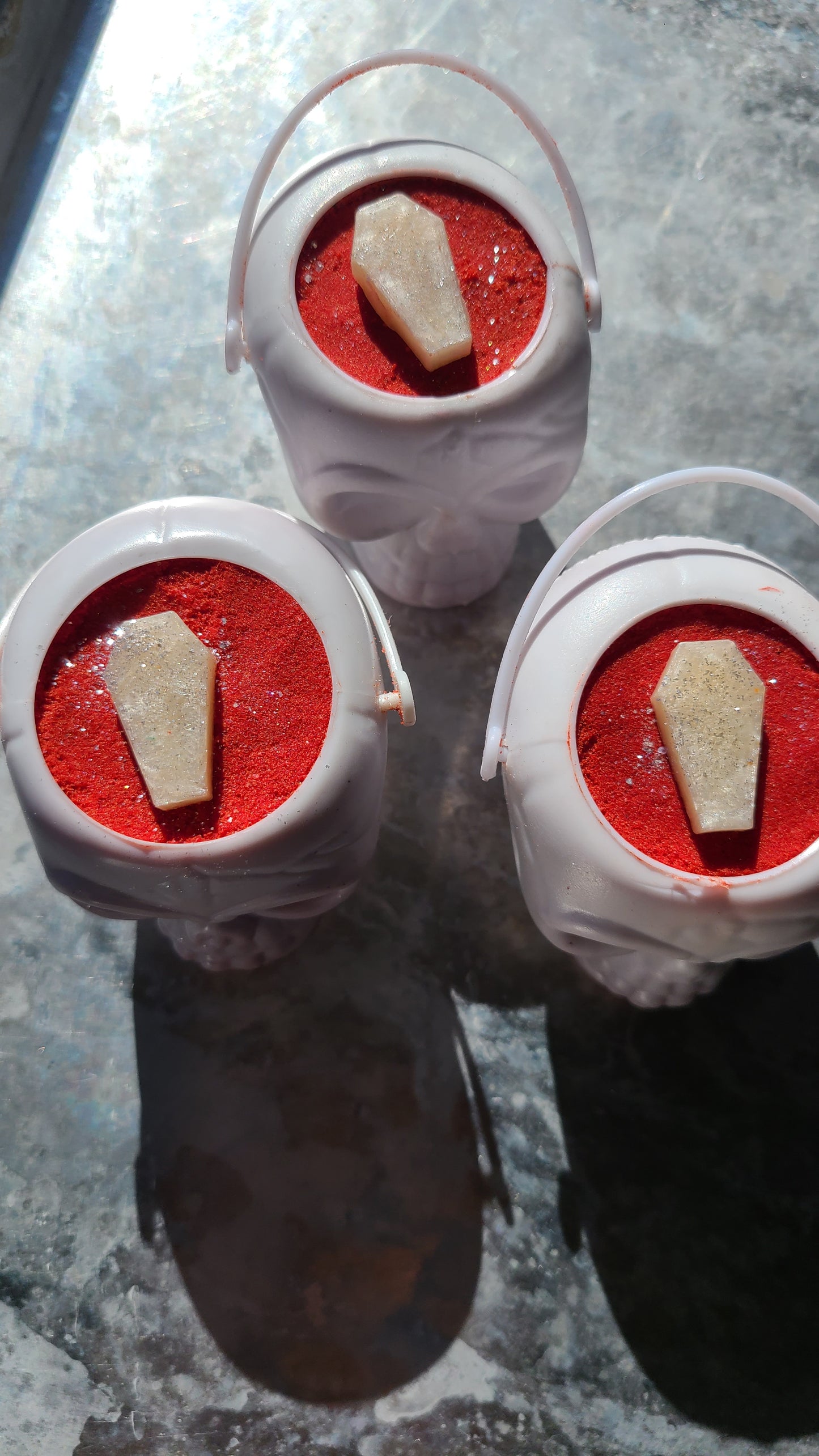 White Skull mini bucket with red bath bomb inside topped with mini white coffin.  halloween 2022